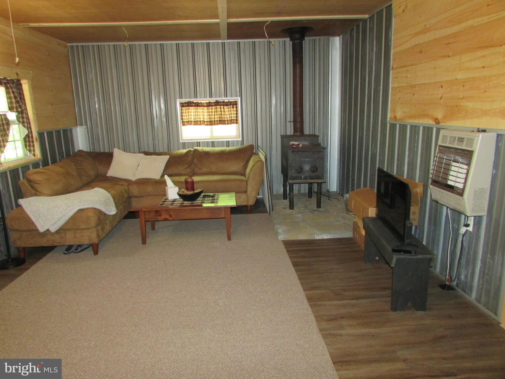 293 Snow Shoe Mountain Forest Road Snow Shoe, PA 16874 - Photo 6 of 38 a living room with furniture window and wooden floor
