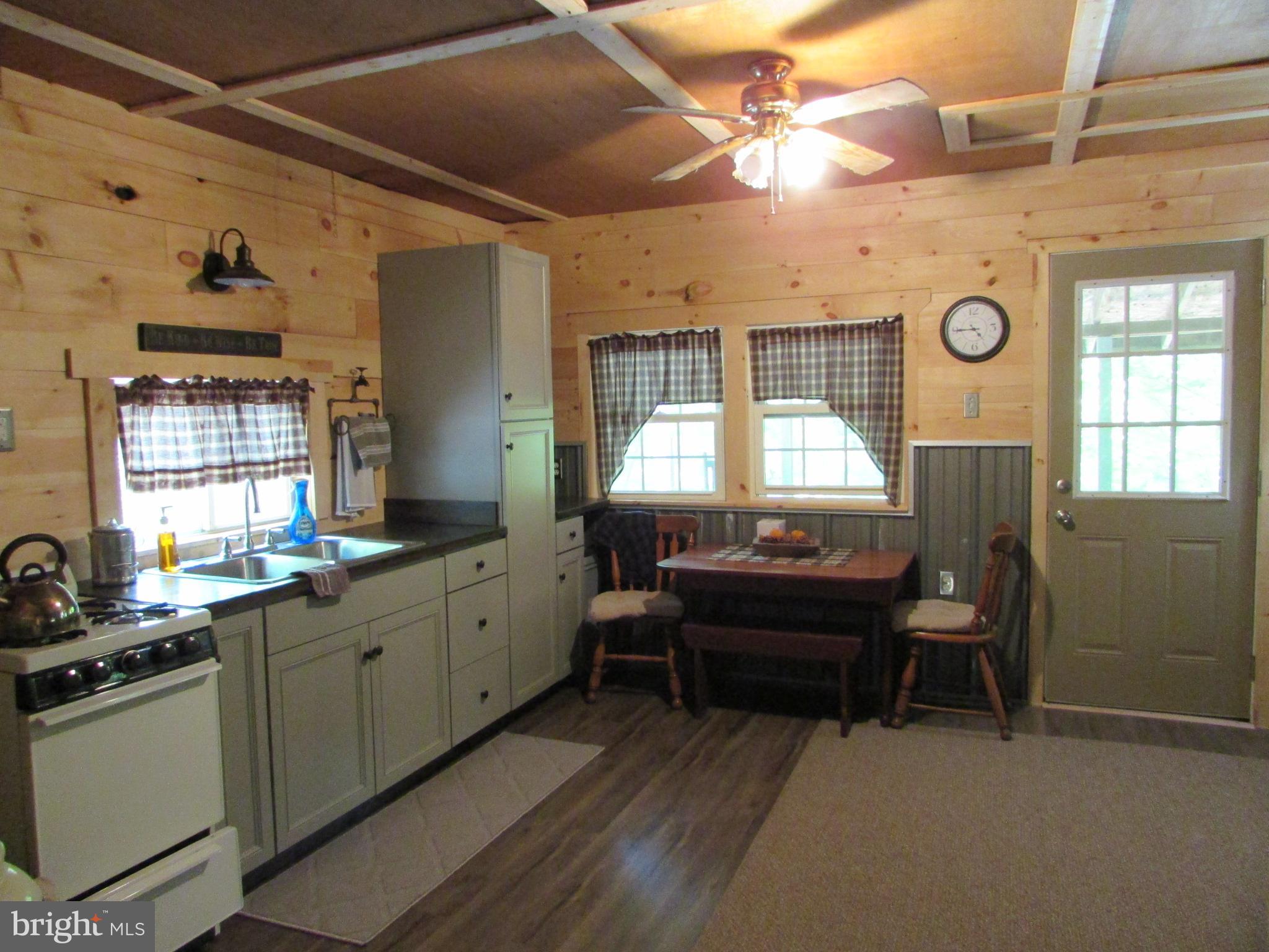 293 Snow Shoe Mountain Forest Road Snow Shoe, PA 16874 - Photo 8 of 38 a large kitchen with a large window and dining table