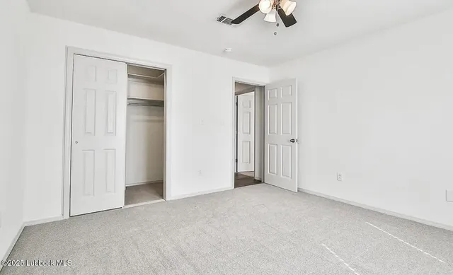 an empty room with ceiling fan