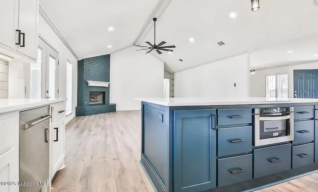 a spacious bathroom with a granite countertop sink a mirror and shower