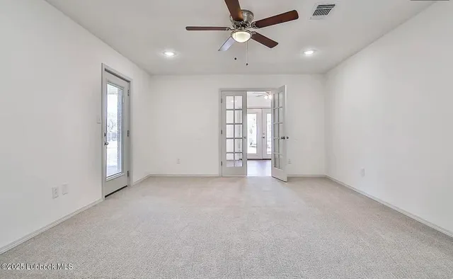 an empty room with closet and windows