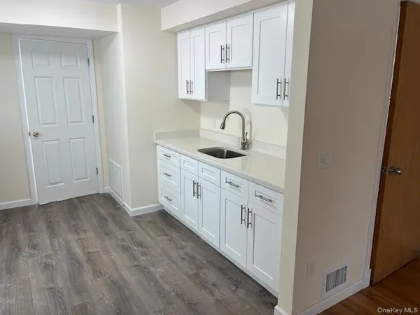 a kitchen with white cabinets