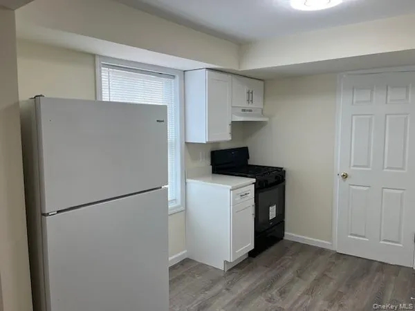 a kitchen with a refrigerator sink stove and cabinets
