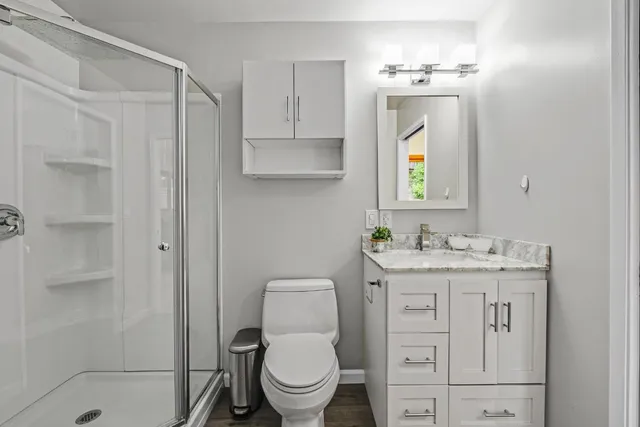 a spacious bathroom with a toilet a sink and shower