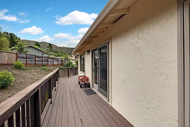 a balcony with wooden floor and city view