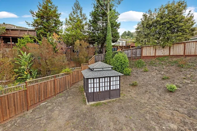 a view of a brick house with a yard