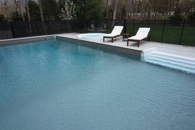 a view of a patio with a table chairs and a backyard