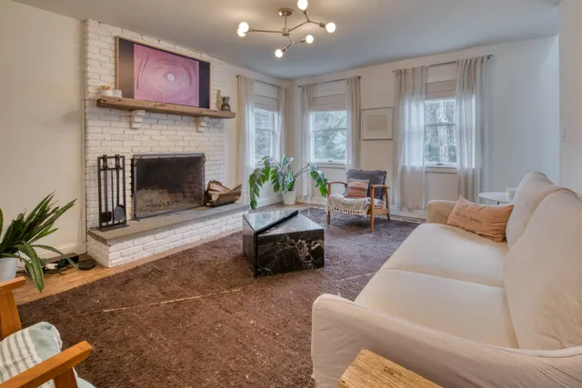 a living room with furniture and a fireplace