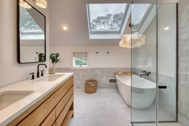 a bathroom with a double vanity sink and a mirror