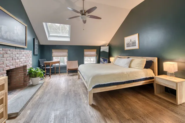 a bedroom with a bed and a fireplace