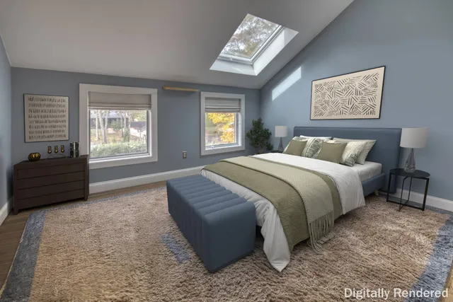 a spacious bedroom with a bed a couch and a window