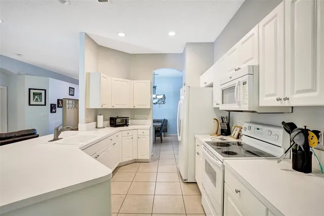 a kitchen with a stove and white cabinets
