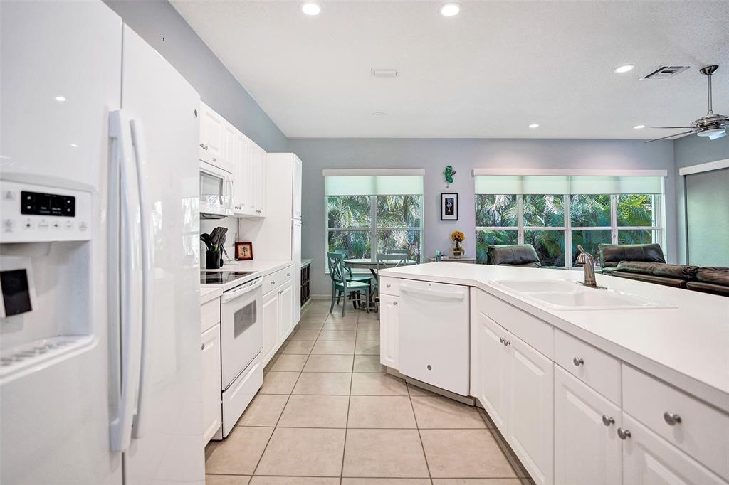 7992 Rockford Road Boynton Beach, FL 33472 - Photo 22 of 48 a kitchen with white cabinets and sink