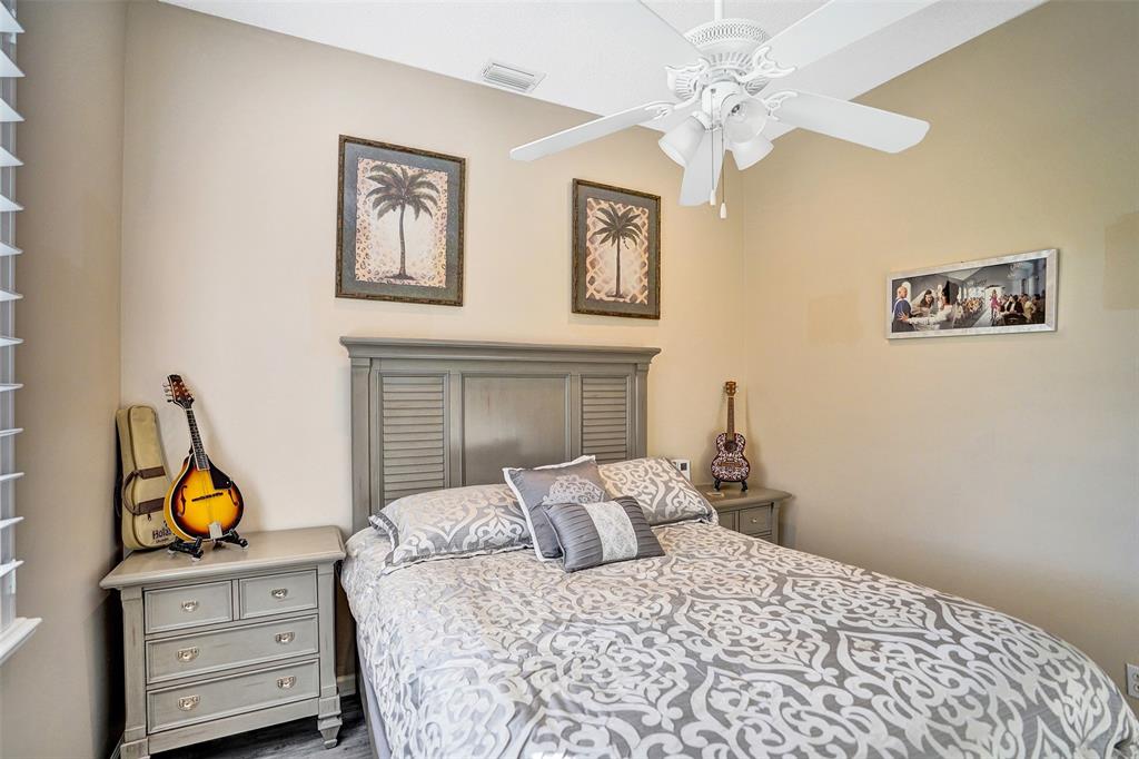 7992 Rockford Road Boynton Beach, FL 33472 - Photo 25 of 48 a bedroom with a bed and a chandelier