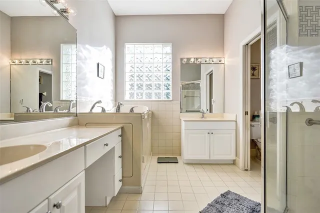 a bathroom with a granite countertop sink mirror and a bathtub