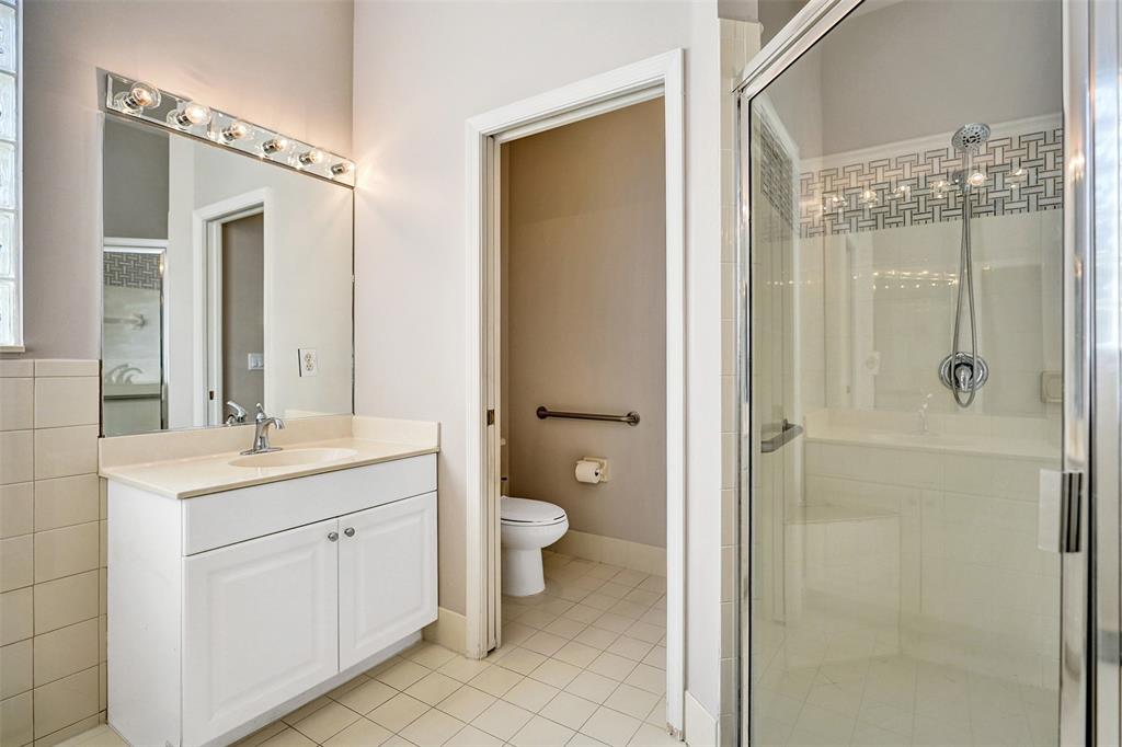 7992 Rockford Road Boynton Beach, FL 33472 - Photo 33 of 48 a bathroom with a double vanity sink toilet and shower