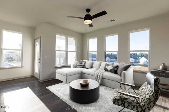 a living room with furniture and a large window