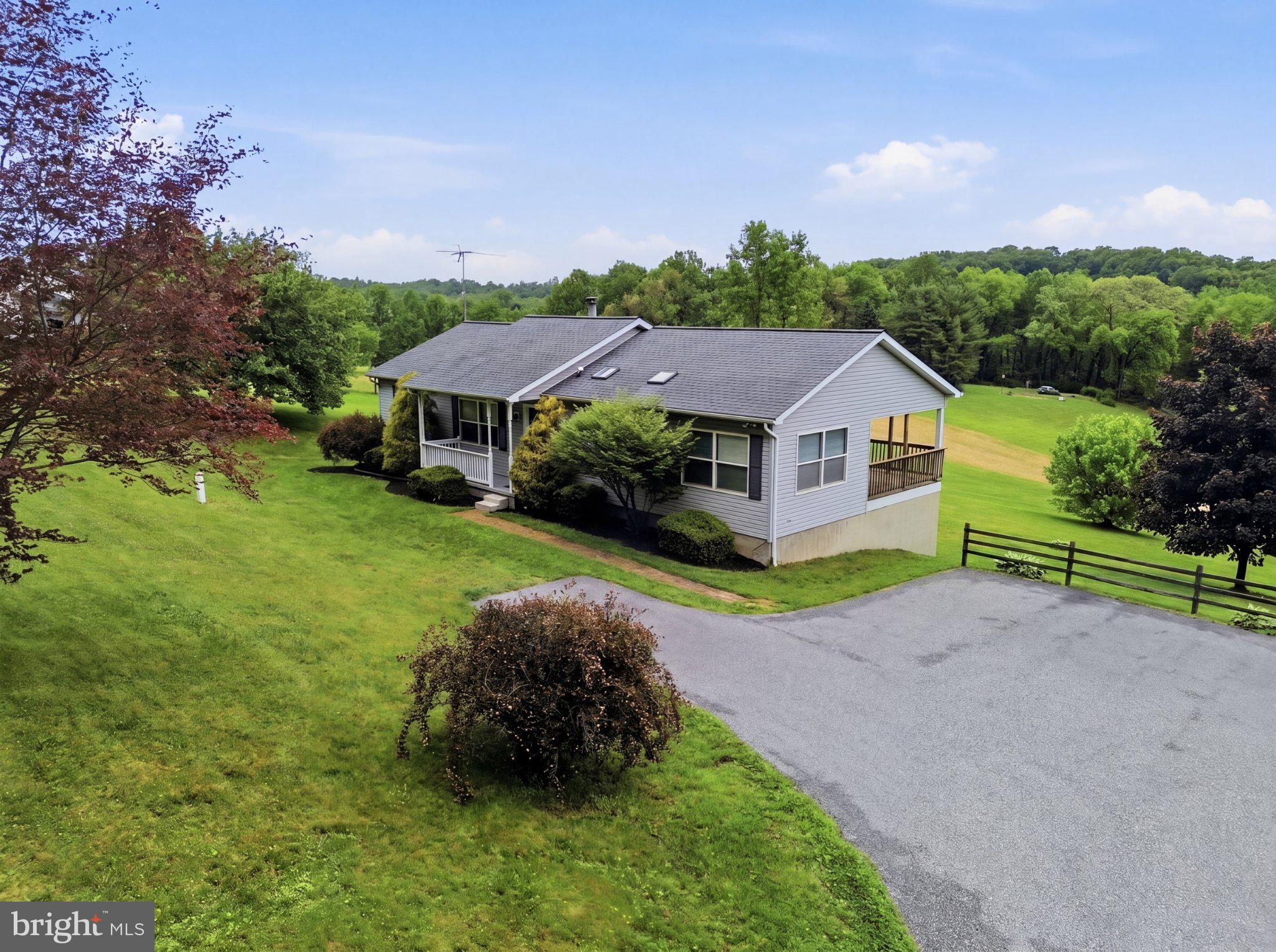 491 Garvine Mill Road Fawn Grove, PA 17321 - Photo 34 of 47 a house with green field in front of it