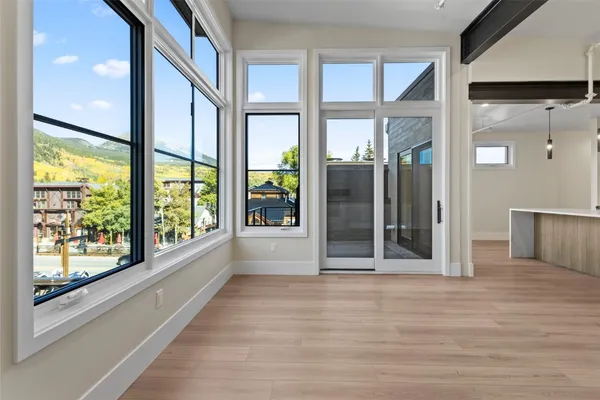 a view of front door and porch with wooden floor