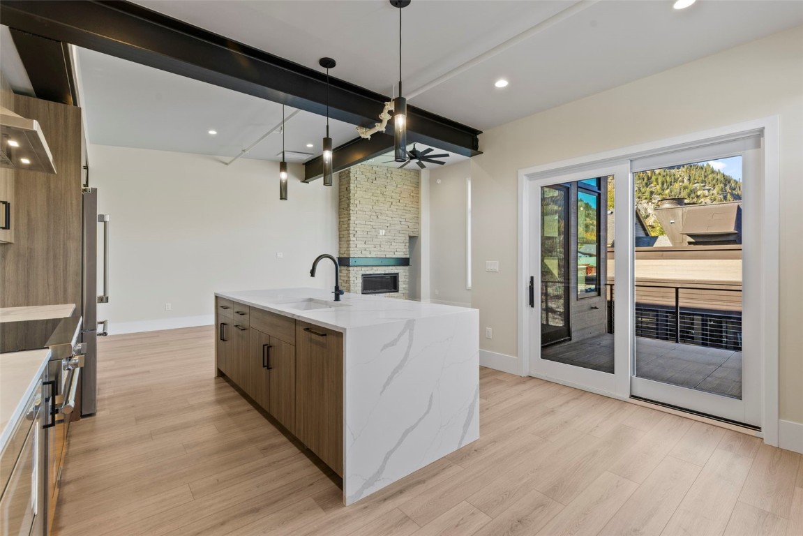 310 East Main Street, Unit 202 Frisco, CO 80443 - Photo 12 of 45 a large white kitchen with a large window a sink and stainless steel appliances