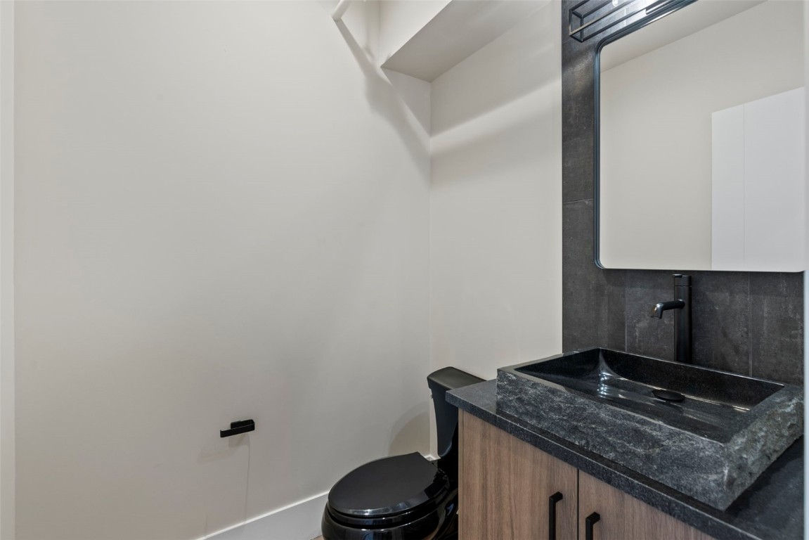 310 East Main Street, Unit 202 Frisco, CO 80443 - Photo 24 of 45 a bathroom with a granite countertop sink and a toilet