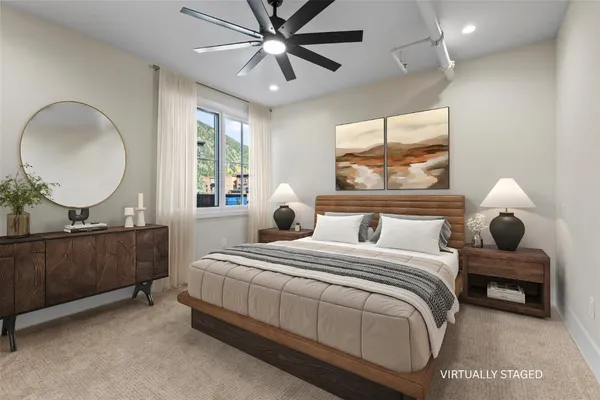 a bedroom with a bed mirror and window