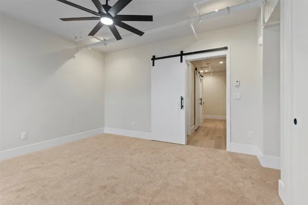 en empty room with closet and a chandelier fan