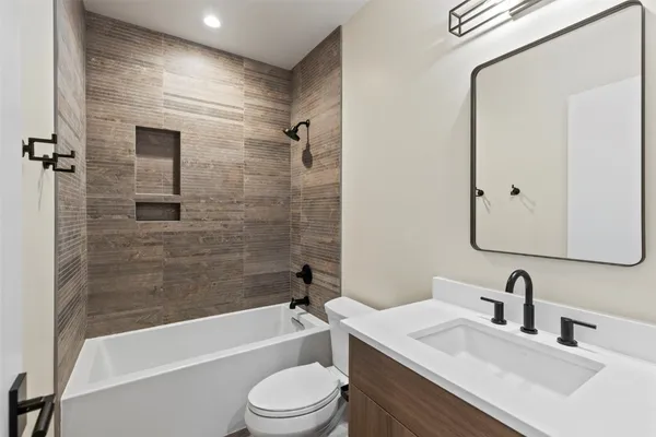 a bathroom with a toilet a sink and bathtub