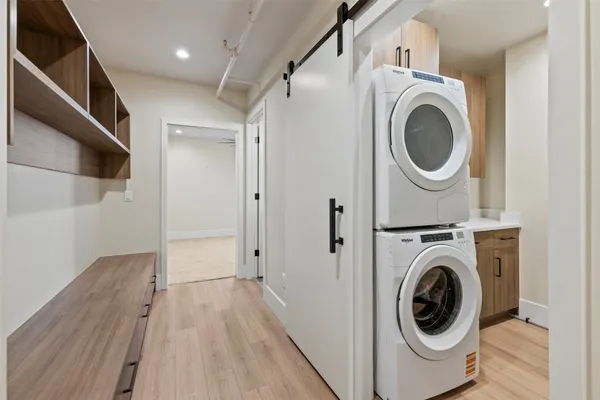a view of a hallway with washer and dryer