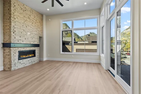 a view of a hallway with wooden floor and a fireplace