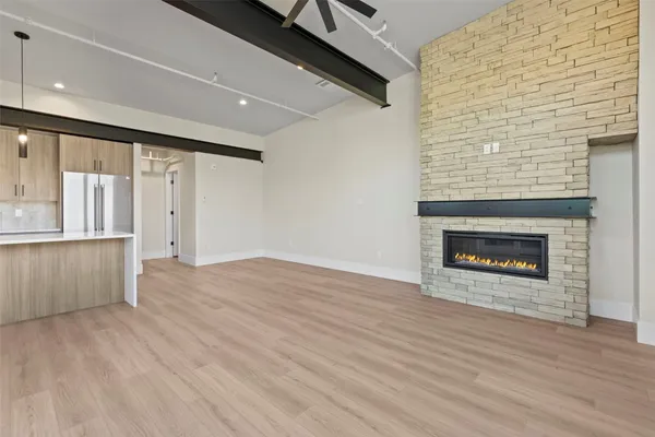 an empty room with wooden floor and fireplace