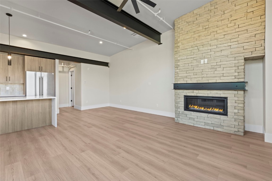 310 East Main Street, Unit 202 Frisco, CO 80443 - Photo 10 of 45 an empty room with wooden floor and fireplace