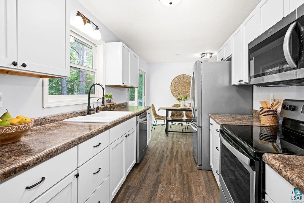 4002 Old Midway Road Hermantown, MN 55810 - Photo 5 of 19 Kitchen featuring sink, dark hardwood / wood-style flooring, stainless steel appliances, and white cabinets