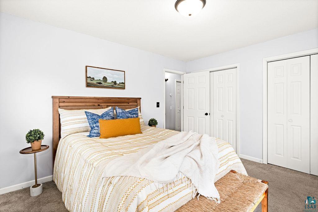 4002 Old Midway Road Hermantown, MN 55810 - Photo 7 of 19 Bedroom featuring multiple closets and carpet