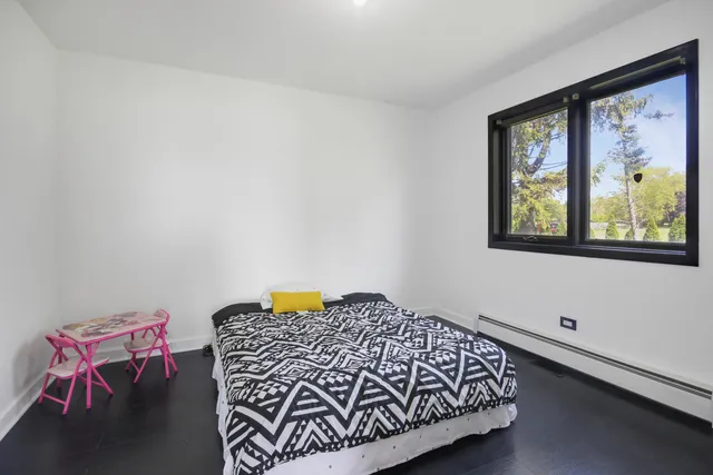 a bedroom with a bed and window