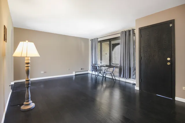 an empty room with wooden floor and a window