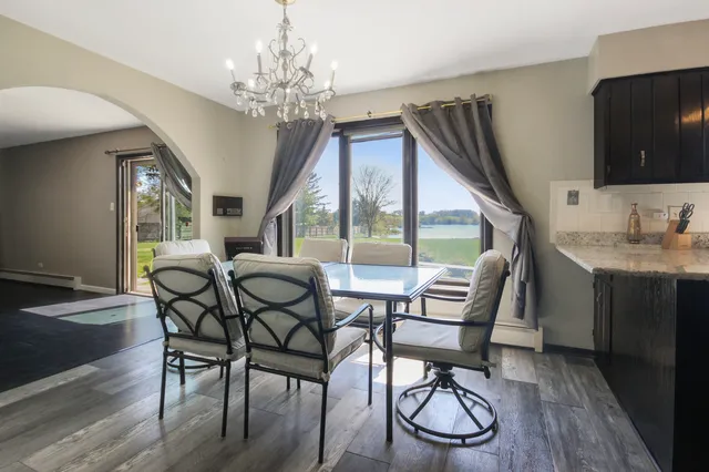 a view of a dining room with furniture wooden floor and chandelier