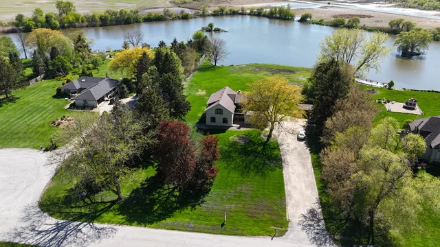 a aerial view of a house with yard and green space
