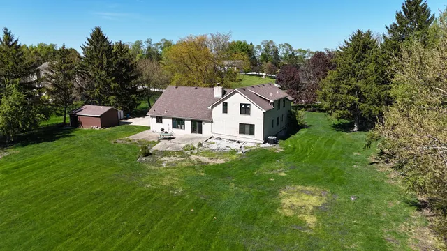 a view of house with backyard outdoor seating and green space
