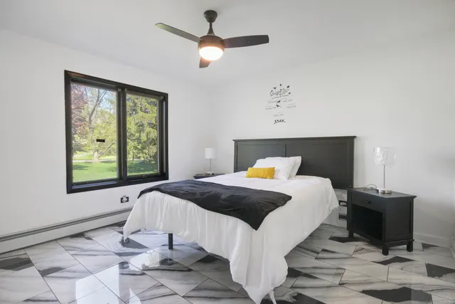 a bed sitting in a bedroom next to a window