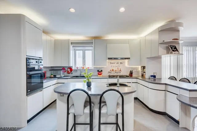 a kitchen with sink a stove and cabinets