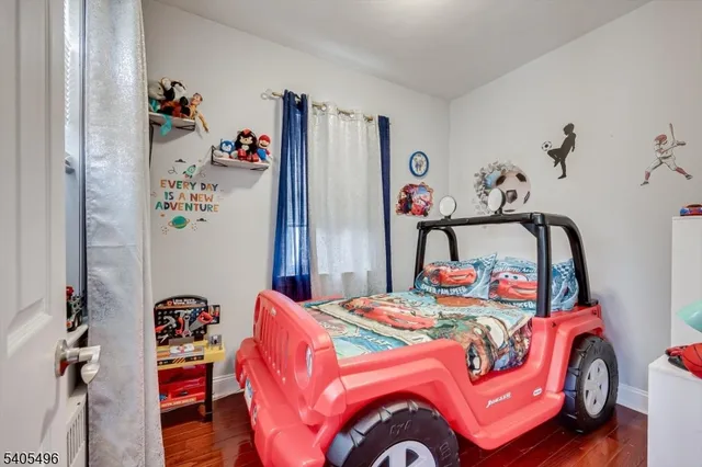 a bedroom with bed and a book shelf