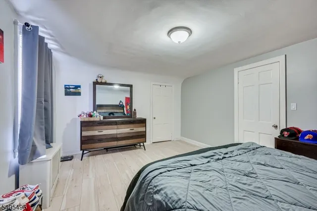 a bedroom with a bed and a dresser