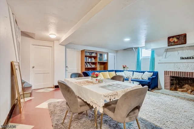 a living room with furniture a table and a fireplace