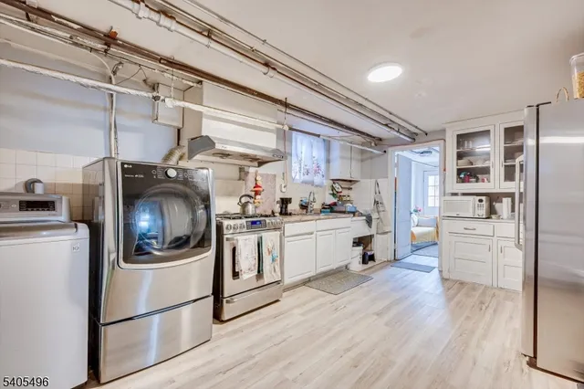 a kitchen with stainless steel appliances a stove a refrigerator and cabinets