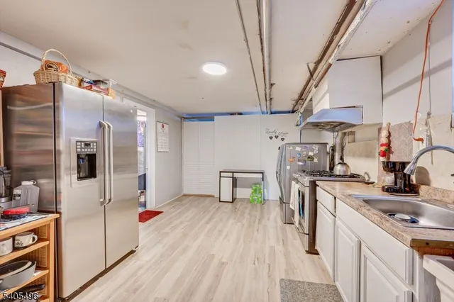 a kitchen with stainless steel appliances a sink stove and cabinets