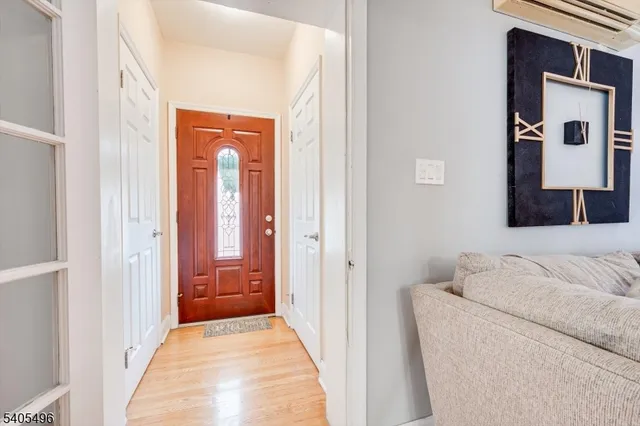 a view of a hallway with a couch and a dining table chair