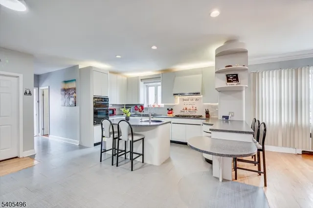 a kitchen with a sink cabinets and wooden floor
