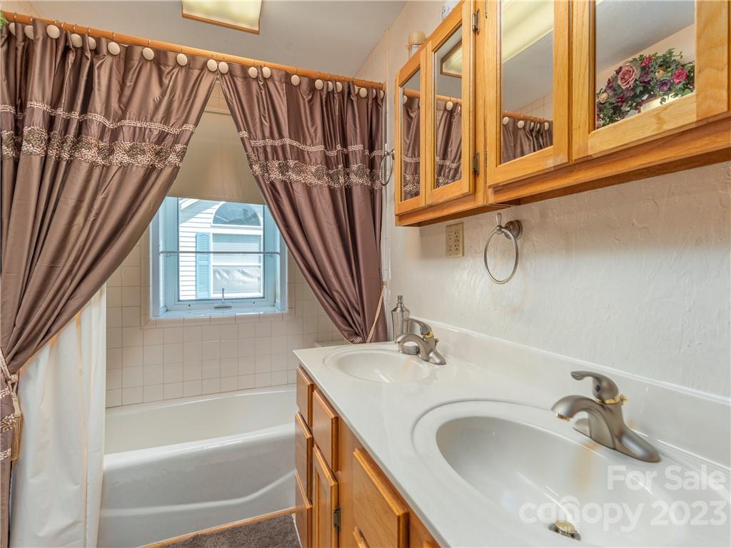 258 Mallard Loop Waynesville, NC 28785 - Photo 14 of 22 a bathroom with a sink and a bathtub