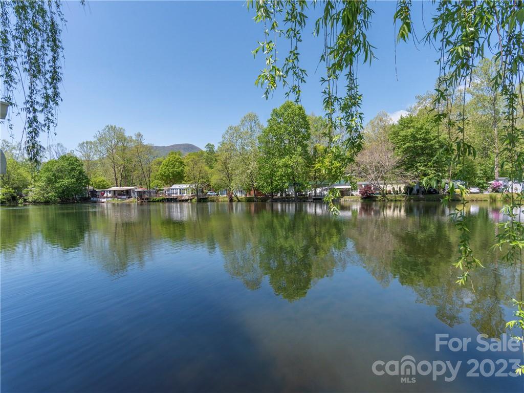 258 Mallard Loop Waynesville, NC 28785 - Photo 19 of 22 a view of a lake with houses in the background